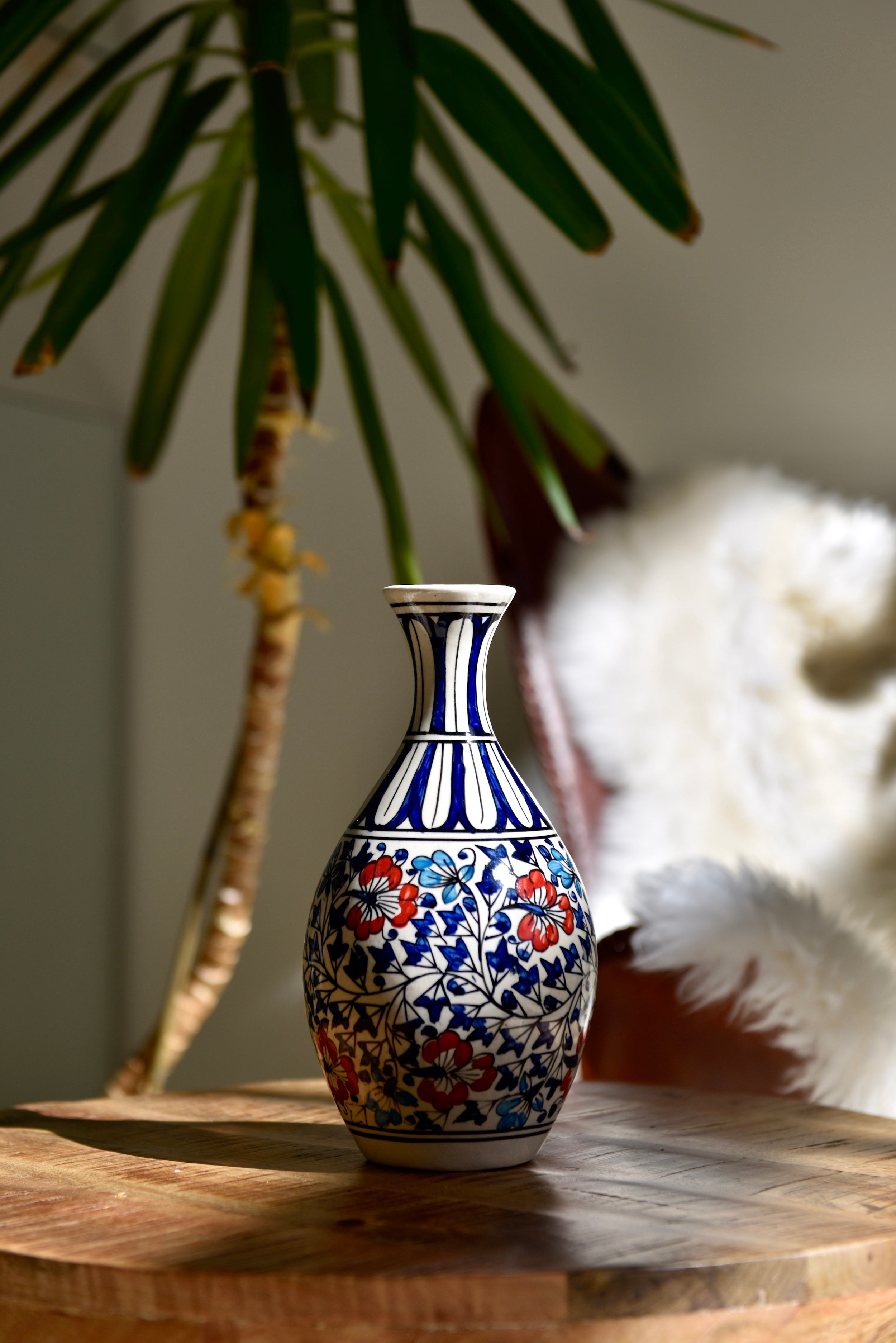 Vase élancé aux motifs floraux rouges, bleus et turquoise